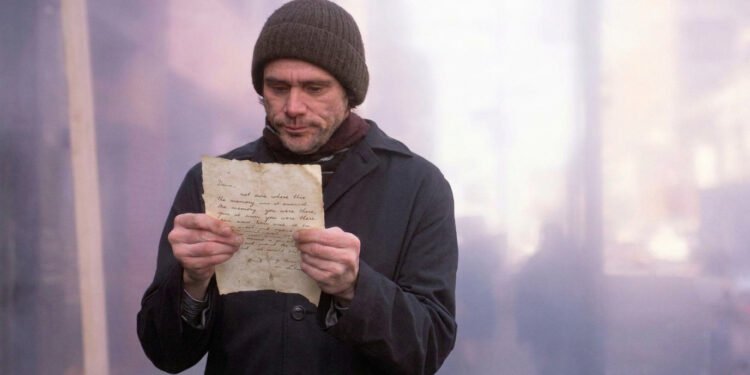 Jim Carrey como Joel Barish lendo uma carta de Clementine em cena de Brilho Eterno de uma Mente sem Lembranças