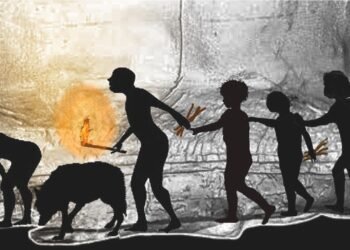 Ilustração de silhuetas de cinco humanos pré-históricos e um cão caminhando em fila por uma caverna escura, um adulto segurando um graveto de pinheiro em chamas para iluminar o caminho.