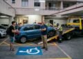 Visitante jovem estaciona o carro em uma vaga destinada a cadeirantes dentro do estacionamento fechado do condomínio. O síndico aciona a fiscalização de trânsito que entra no prédio e guincha o veículo, reforçando que o Código de Trânsito Brasileiro se aplica integralmente em vias internas.