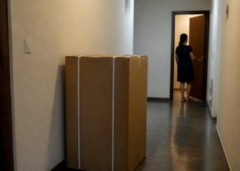 Caixas de entrega paradas no corredor do prédio, em frente à porta errada