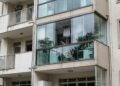 Moradora fecha a área de serviço do apartamento com vidro para evitar a entrada de chuva e, após uma reclamação anônima, recebe notificação do condomínio para desfazer a alteração